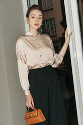 Tailored silk wide-leg pants with high-rise waist and pleated front for elegant drape